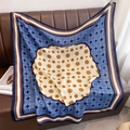 Detail of elegant blue and beige cotton linen scarf draped on a leather sofa - 90x90cm / Blue