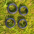 Deep blue sand stone rings with star-like glitter on natural green moss background - Synthetic Blue Goldstone