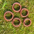 Polished red-brown goldstone ring rings with sparkling finish on natural moss background - Synthetic Goldstone