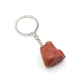 Natural reddish-brown raw stone keychain with silver metal ring on white background - Red Jasper