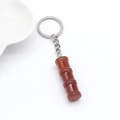 Handcrafted red agate bamboo-shaped keychain with silver metal ring on white background - 1Pc Red Agate