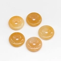 Five orange natural stone donuts for DIY pendants with smooth oily luster and round holes - Topaz