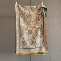 Macro detail of cashmere-like scarf showing yellow fringe and beige paisley pattern - Brown (GSJ-632-Brown)