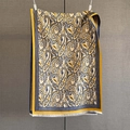 Close-up of yellow paisley cashmere-feel scarf showing intricate jacquard texture and fringes - Yellow
