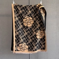 Close-up of knit scarf with camellia flower pattern and fringe trim in black and gold - Black Brown / 186*70cm