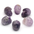 Set of 6 hand-carved amethyst crystal skulls with natural purple stone textures - Amethyst