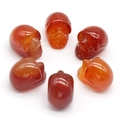 Set of six handcrafted 1-inch red agate crystal skull carvings with natural stone texture - Red Agate