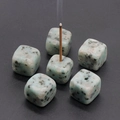 Green natural stone cube incense holders with black veining on dark background - Tianshan Blue