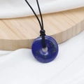 Deep blue lapis lazuli donut pendant necklace with black hand-woven adjustable cord - Lapis Lazuli
