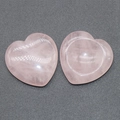 Pink rose quartz heart-shaped palm stone and small tray set on textured background - Rose Quartz