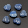 Polished heart-shaped blue aventurine quartz stones scattered on black background - Blue Aventurine