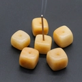 Polished yellow natural stone cube incense holder with a burning incense stick - Topaz