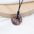 Pink rhodonite donut pendant with natural black marble veins on black cord necklace - Rhodonite