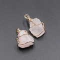 Handmade wire-wrapped raw rose quartz pendants with gold finish on dark background - Rose Quartz