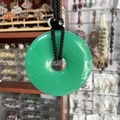 Natural emerald green crystal donut pendant necklace with black woven cord and bead detail - Dyed Malaysian Jade