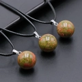 Three 14mm natural unakite crystal spheres on black cords with silver-colored bails - Unakite
