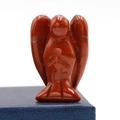 Polished red jasper angel figurine with natural veins on a blue textured box - Red Jasper