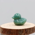 Polished green aventurine crystal duck figurine on a rustic wooden base for home decor - Green Aventurine