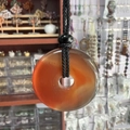 Translucent red agate donut pendant necklace with black braided cord and beads - Red Agate