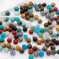 Mixed natural stone pumpkin charms with silver loops, including tiger eye and turquoise - Random