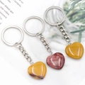 Polished heart-shaped stone keychains in yellow and deep red marble textures - Yellow Jasper