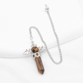 Tiger eye stone hexagonal pillar pendulum with bat wings decoration on white background - Tiger's Eye