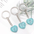 Three turquoise-style heart keychains with natural stone textures and silver metal rings - Synthetic Blue Turquoise