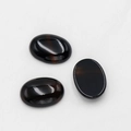 Polished 18x25mm oval black agate flatback cabochon with subtle brown banding detail - Black Agate