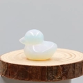 Hand-carved opalite duck gemstone figurine with iridescent finish on wooden base - Synthetic Opal