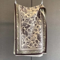 Close-up of ocean shell prints and delicate fringe on cashmere-like autumn scarf - Green
