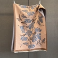 Detailed close-up of apricot floral scarf featuring blue accents and white fringe tassels - Blue
