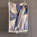 Detailed view of the soft abstract geometric pattern and tassels on a thick winter scarf - Navy Blue