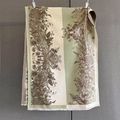 Detailed view of floral jacquard patterns and soft tassel trim on a thick winter scarf - Beige Green