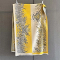 Detail of yellow and beige patchwork scarf with gray floral print and fringe edges - Beige