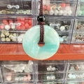 Natural light green stone donut pendant necklace with brown braided rope cord - Amazonite
