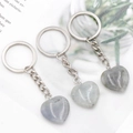 Three heart-shaped labradorite gemstone keychains with silver rings on white background - Labradorite