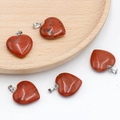Five heart-shaped red jasper stone pendants with silver clasps on a wooden tray - Red Jasper