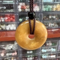 Natural yellow jade donut pendant necklace with dark brown woven cord and black bead accent - Old Yellow Jade