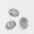Polished 18x25mm oval light gray cabochon stones with natural black inclusions - Labradorite