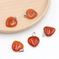 Five carnelian agate heart pendants with silver metal loops on a round wooden tray - Red Agate
