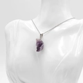 Purple amethyst moon face carved pendant necklace on a silver chain displayed on a mannequin - Amethyst