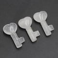 Tres colgantes de llave con forma de corazón en cristal blanco sobre fondo oscuro - Cristal de roca