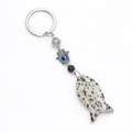 Fish-shaped spotted stone keychain with metal Evil Eye Hamsa charm and black bead - Spotted Stone