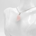 Pink rose quartz crescent moon pendant necklace with silver chain on a white model - Rose Quartz