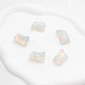Set of five carved opalite pig figurines with milky translucent iridescent finish - Opal (Synthetic)