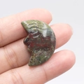Hand-carved Unakite crescent moon face stone with natural green and pink textures - Dragon Blood Stone