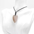 Polished 40mm rose quartz heart pendant necklace with simple black cord on a model - Grey Agate