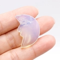 Carved moon face opalite stone pendant with iridescent blue and milky white highlights - Opal (Synthetic)