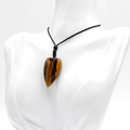 Natural tiger eye stone heart pendant necklace with black braided rope on white bust - Tiger's Eye