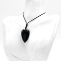 Polished black obsidian heart pendant necklace with minimalist woven cord on model - Obsidian
